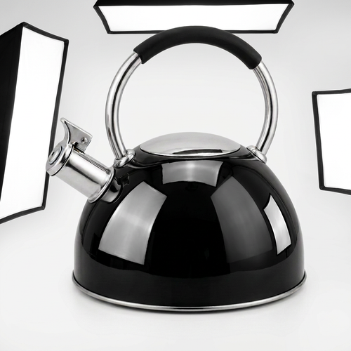 Shiny black stovetop kettle with silver trim and a black handle grip